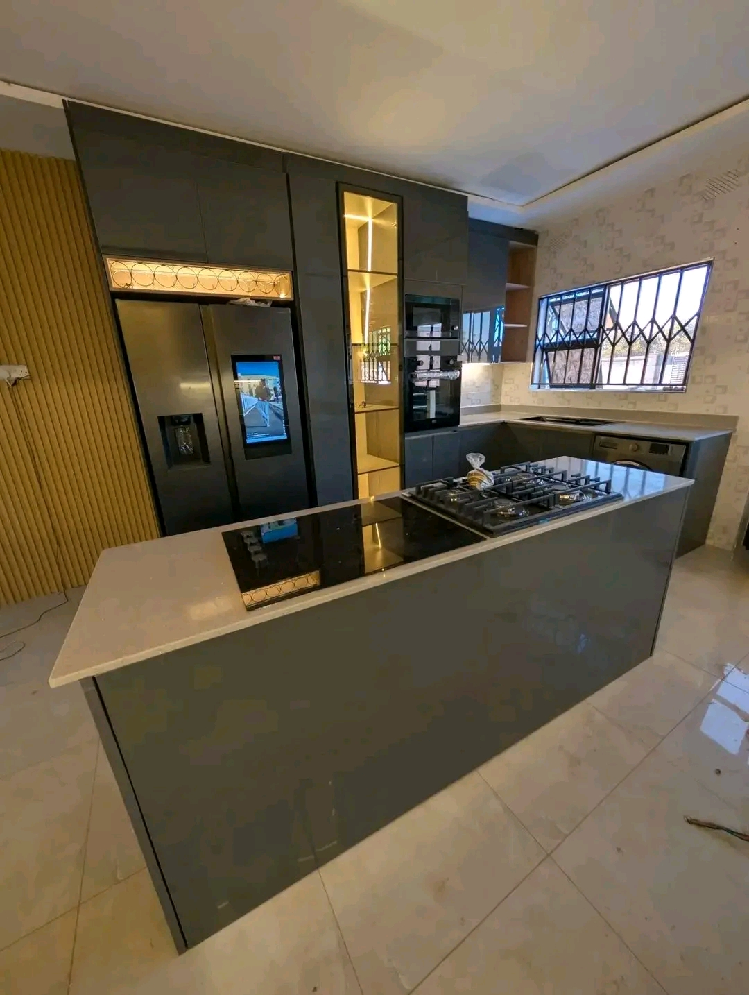 Premium dark kitchen with smart fridge, gas hob and quartz island
