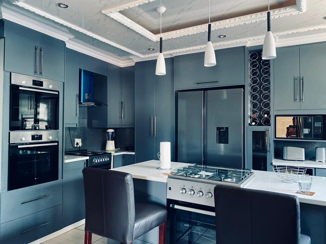 Bespoke dark grey kitchen with wine rack and built-in ovens