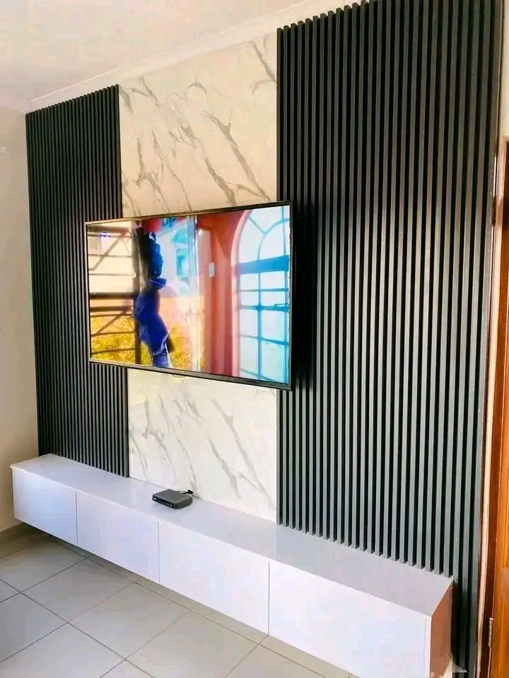 Custom TV media wall with marble inlay and floating cabinet
