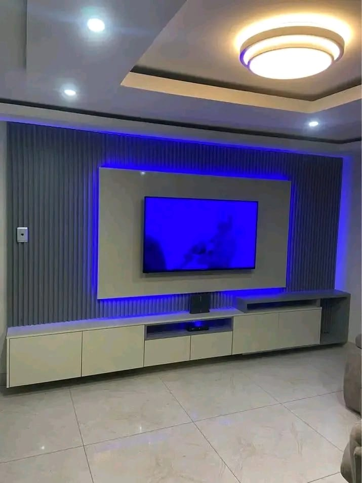 Blue LED-backlit TV feature wall with floating media console