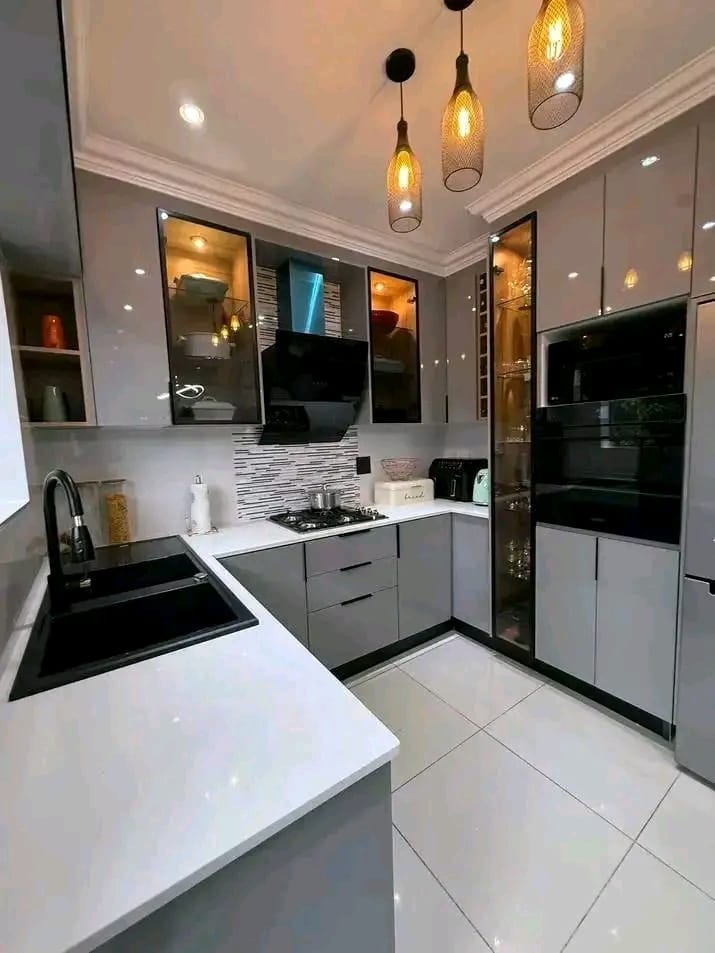 Grey gloss U-shaped kitchen with pendant lighting and mosaic splashback